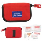 Red first aid kit with supplies, labeled Hampton Inn & Suites.