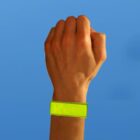 A raised fist with a yellow wristband against a blue background.
