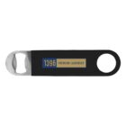 A black bottle opener with a metal tip and a round hole at the opposite end. The handle features a label with the text 1396 Premium Lagerbier in yellow and blue.