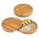Round bamboo cheese board set with lid and four cheese knives inside.