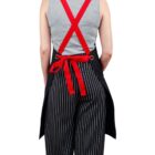 Person with braided hair wearing a gray top and striped pants, seen from the back.