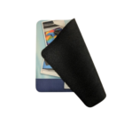 Partially folded On The Move black mouse pad reveals a laptop design, ideal for travel.