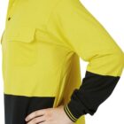 A person in a yellow and black long-sleeve polo shirt, featuring a chest pocket and stripe detailing on the collar and cuffs, stands with one hand on their hip. The image focuses on the upper body.