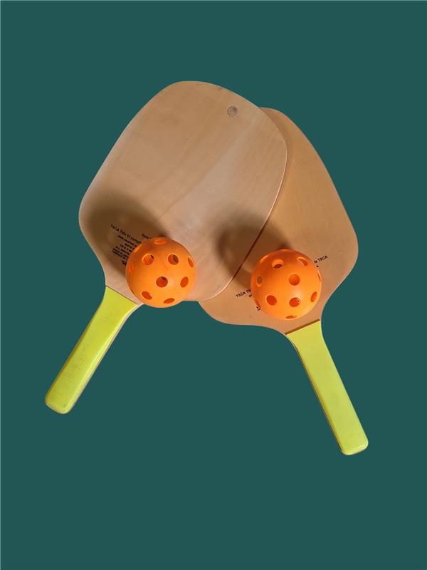 Promotional Pickleball Merch – two wooden paddles with orange balls