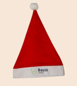 Red Santa hat with a white brim and pom-pom, featuring a Basin Energy logo.