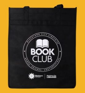 Black tote bag with Book Club and library logos on a yellow background.
