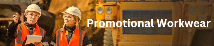 Two workers in hard hats discuss tips near equipment; text reads Promotional Workwear.