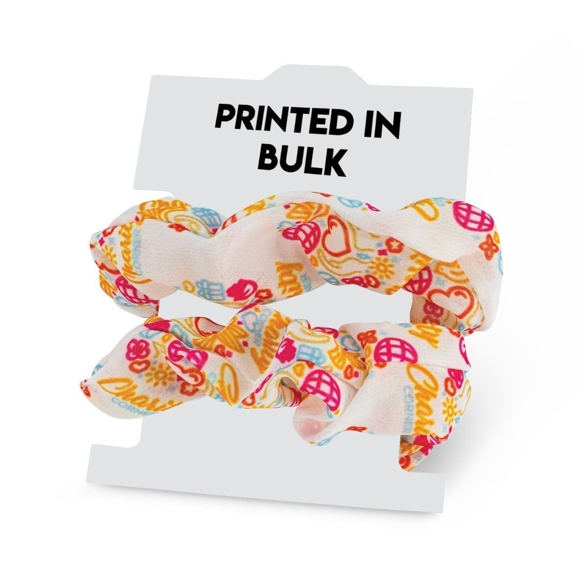 A colorful scrunchie with a playful pattern featuring hearts, peace signs, and flowers in red, orange, and blue on a white background. It is displayed against a packaging card reading PRINTED IN BULK.