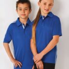 Two kids in blue polo shirts stand side by side against a white background.