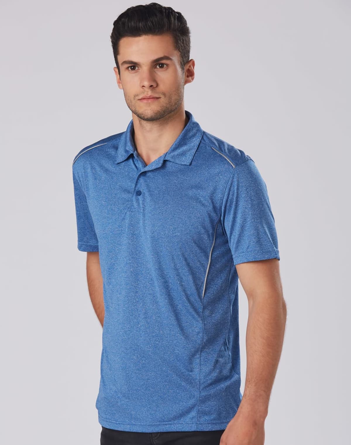 Man wearing a blue polo shirt against a plain background.