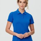 Woman in blue polo shirt against plain background.