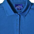 Blue collared shirt with buttons and Winning Spirit label.