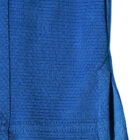 Close-up of textured blue fabric with a right-side seam and small slit.