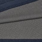 Close-up of gray fabric with small black polka dots and dark blue textured borders.
