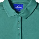 Green collared polo shirt with four buttons and Winning Spirit label.