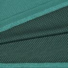 Close-up of green fabric with textured stitching and a dotted pattern on overlapping layers.