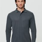 Man in a dark gray long-sleeve polo shirt against a light gray background.