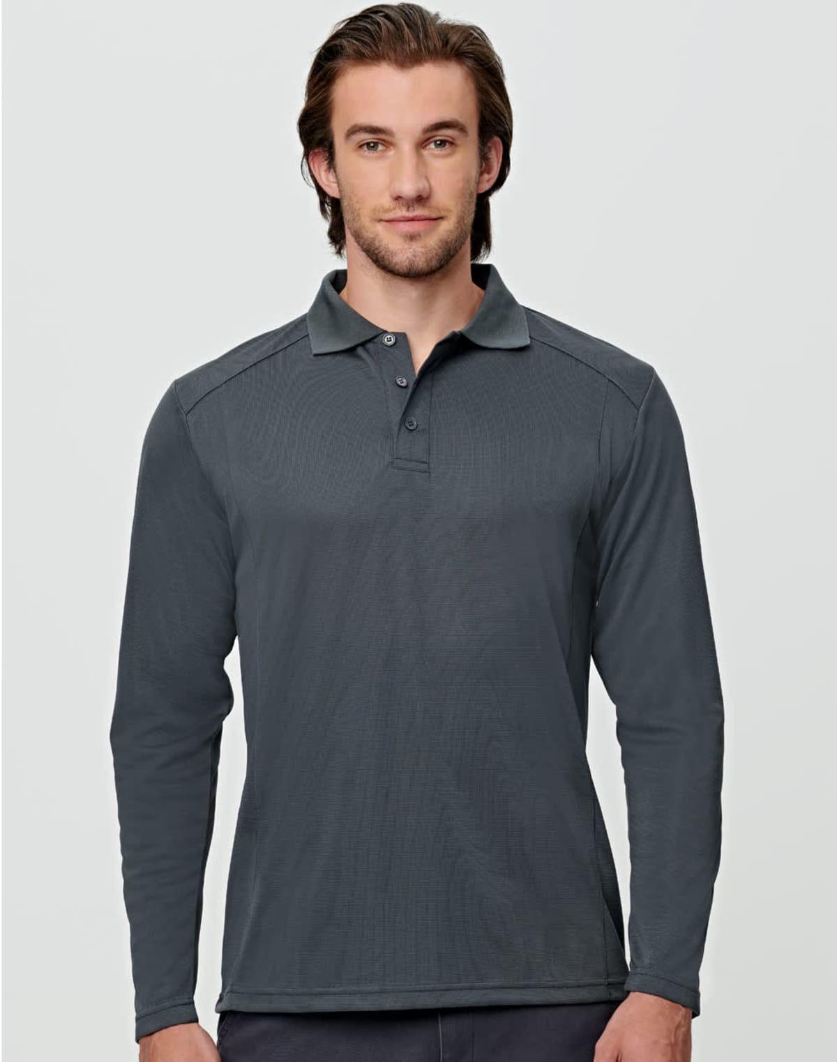 Man in a dark gray long-sleeve polo shirt against a light gray background.