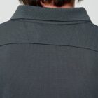 Back view of a person wearing a gray collared shirt with short hair visible.