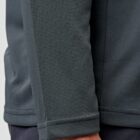 Close-up of a persons arm in a dark gray textured long-sleeve shirt.