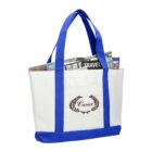 White and blue tote bag with newspapers and a travel magazine inside.