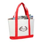 White tote bag with red handles, filled with newspapers, featuring a laurel wreath logo.