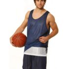 Man in a blue basketball outfit holding a basketball against a white background.
