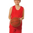 Smiling child in red sports outfit holding a basketball.