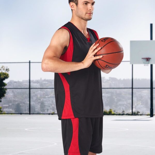 Man holding a basketball on an outdoor court.