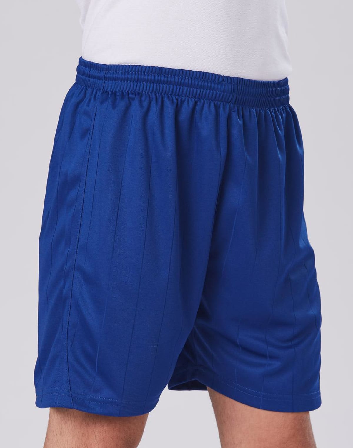 Person wearing blue athletic shorts and a white shirt.