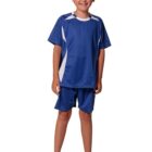 Child in blue soccer uniform and white shoes, smiling against a white background.