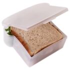 Sandwich in a white plastic sandwich container, slightly open, with lettuce visible.