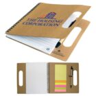 Brown spiral notebook with handle, pen holder, sticky notes, and lined paper.