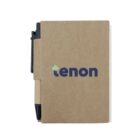 A brown cardboard-style notebook with a black pen attached to the spine. The notebook cover features the text tenon in blue lowercase letters, with a small green cross over the t.