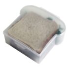 Sandwich in a translucent sandwich-shaped container.