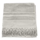 A folded beige towel with fringe tassels along the bottom edge, featuring textured stripes across the top section.