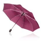 A maroon umbrella with a black handle, open and tilted on a white background.