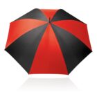 A red and black umbrella with alternating colored panels is fully opened, viewed from above, against a white background. The red and black sections create a striking pattern.