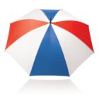 A large umbrella with alternating red, blue, and white panels, viewed from above. The panels form a symmetrical, colorful pattern.