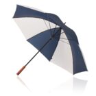 A large closed umbrella with a wooden handle and metal shaft. The canopy features alternating panels of dark blue and white fabric. The umbrella is positioned diagonally against a white background with a faint reflection below.