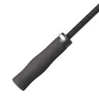 Close-up of a black jump rope handle with a textured grip and attached cable.