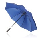 Blue umbrella with a black handle, open and lying on a white reflective surface.