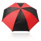 A red and black alternating panel umbrella viewed from above on a white background.