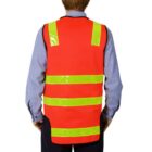 Person facing away, wearing a red safety vest with yellow reflective stripes.
