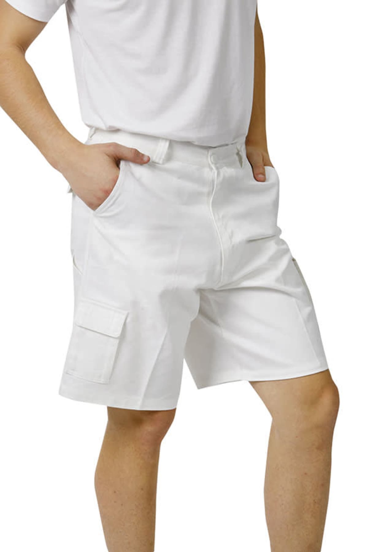 Person wearing white cargo shorts and a white t-shirt with hands in pockets.