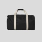 Black duffel bag with white handles on a plain light gray background.