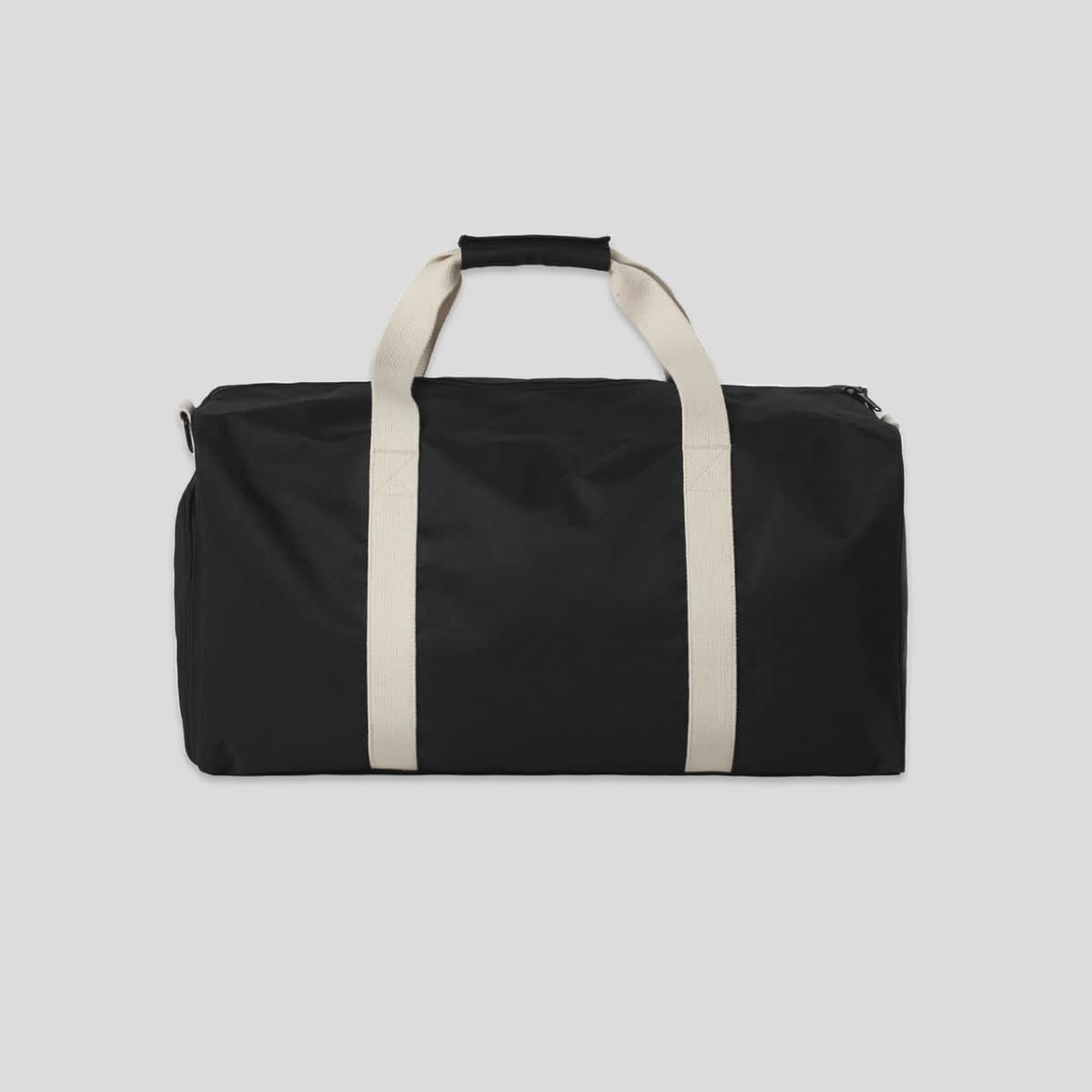 Black duffel bag with white handles on a plain light gray background.