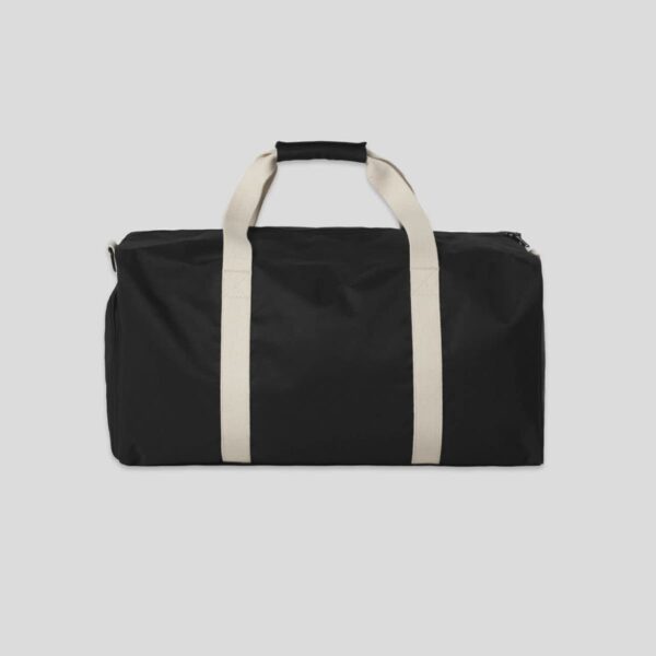 Black duffel bag with white handles on a plain light background.