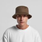 Man in a brown bucket hat and white shirt looking directly at the camera.