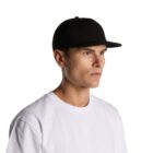 Man in a white t-shirt and black cap looking to the side against a white background.